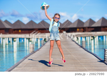 Adorable little girl having fun on wooden jetty Adorable little girl having fun on wooden jetty 20827090