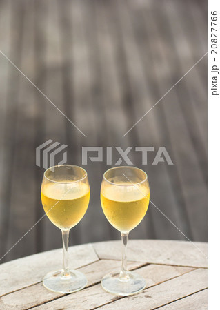 Two glasses of tasty white wine at sunset on Two glasses of tasty white wine at sunset on 20827766