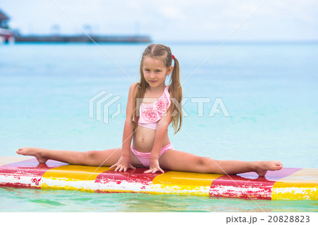Little adorable girl on a surfboard in the Little adorable girl on a surfboard in the 20828823