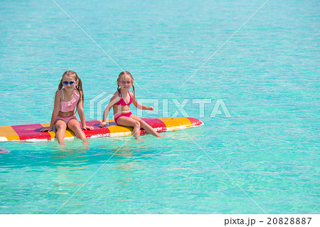 Little adorable girls on a surfboard in the Little adorable girls on a surfboard in the 20828887