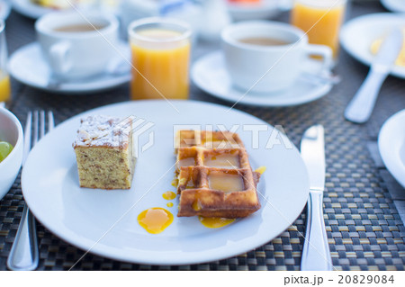 Delicious waffles, cake, coffee and juice served Delicious waffles, cake, coffee and juice served 20829084