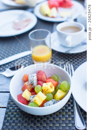 Fresh fruit salad, coffee with milk and juice Fresh fruit salad, coffee with milk and juice 20829476