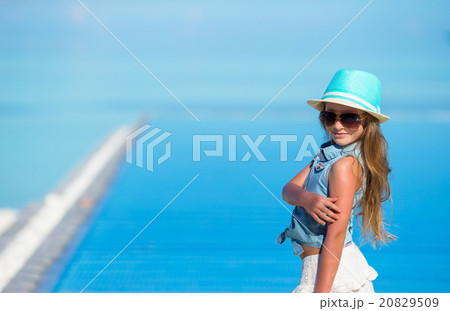 Cute girl in hat at beach during summer vacation Cute girl in hat at beach during summer vacation 20829509