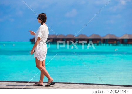 Young beautiful girl listening to music on a 20829542