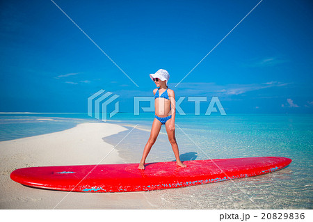 Little adorable girl practice surfing position at Little adorable girl practice surfing position at 20829836