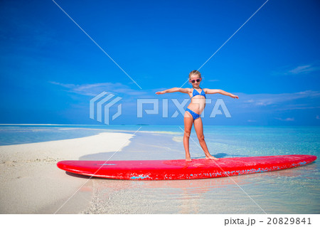 Little adorable girl practice surfing position at 20829841