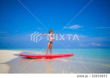 Little adorable girl practice surfing position at Little adorable girl practice surfing position at 20829843