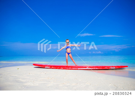 Little adorable girl practice surfing position at 20830324