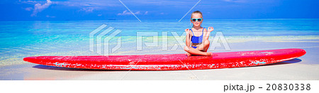 Little girl in yoga position meditating on 20830338