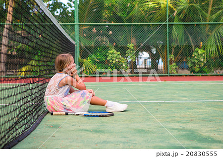 Little girl playing tennis on the court 20830555
