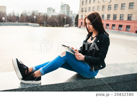 Girl surfing on tablet against city background 20832580