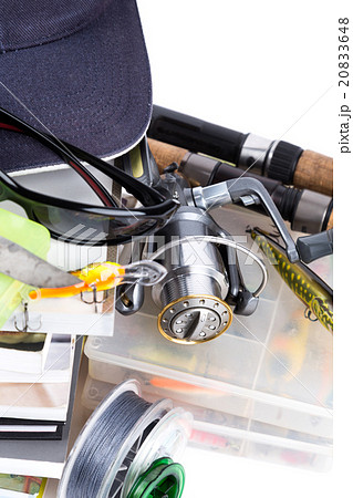 fishing tackles and baits with cap on books 20833648