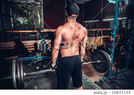 bodybuilder doing exercises with dumbbells 20835144