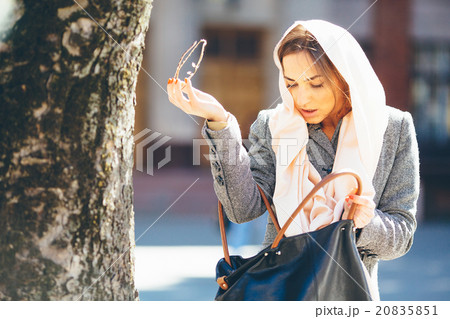 girl looking for something in a bag girl looking for something in a bag 20835851