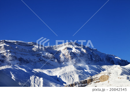 Snowy mountains at sun windy day 20842545