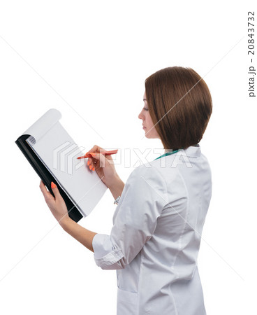 Doctor girl standing sideways and writes on the tablet. 20843732