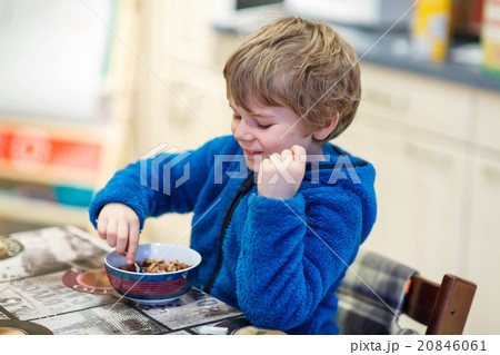 Little kid boy eating cereals for breakfast Little kid boy eating cereals for breakfast 20846061