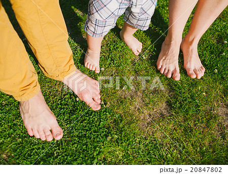 Happy family standing on grass in warm summer day Happy family standing on grass in warm summer day 20847802