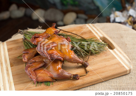 Smoked quail, partridges, chickens on a wooden Smoked quail, partridges, chickens on a wooden 20850175