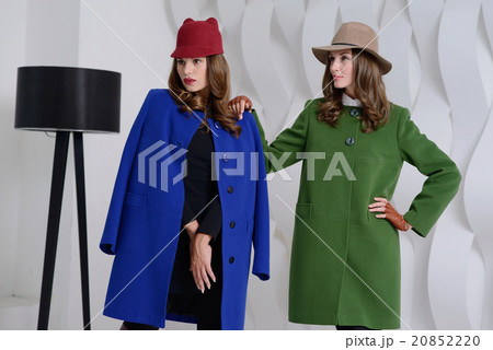 Girls in studio posing at coats Girls in studio posing at coats 20852220