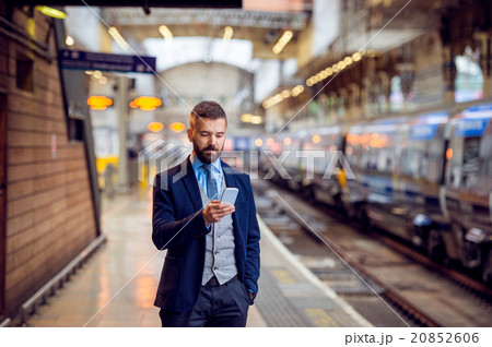Hipster businessman with smartphone, waiting at Hipster businessman with smartphone, waiting at 20852606