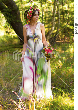 Attractive woman in wreath of flowers. 20852985