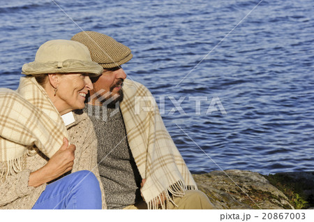senior couple by lake blanket around shoulders senior couple by lake blanket around shoulders 20867003