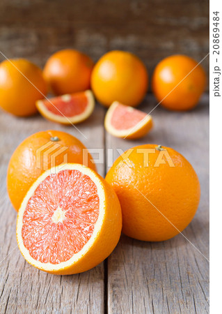 Fresh oranges with slices on wooden background. 20869484