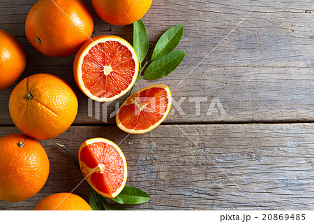 Fresh oranges with slices and leaves on wooden 20869485