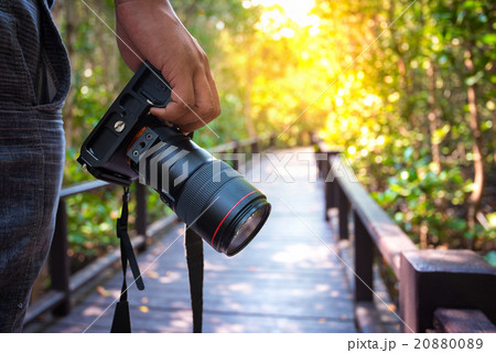 Man holding his camera Man holding his camera 20880089