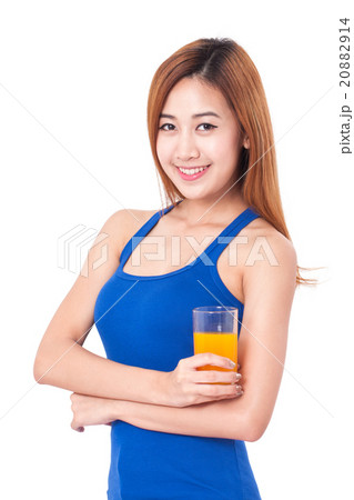 Portrait of young woman drinking orange juice. 20882914