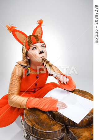 Young woman in image of squirrel writing with 20883289