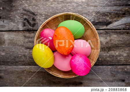 Easter eggs in the basket on rustic wood 20883868