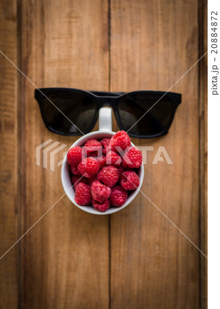 Rasberry in white cup and black sunglasses  20884872