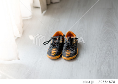 Old and dirty orange sport shoes on gray floor  20884878