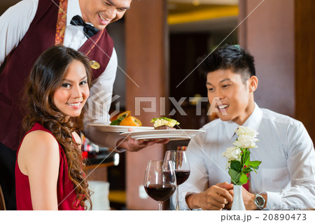 Chinese waiter serving dinner in restaurant Chinese waiter serving dinner in restaurant 20890473