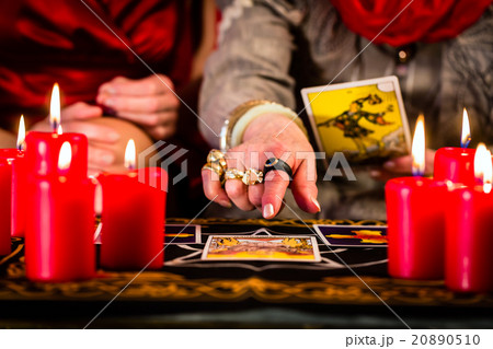 Fortuneteller laying Tarot cards with client 20890510