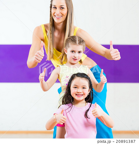 Dance teacher giving kids Zumba dancing class 20891387