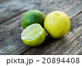 Two limes and sliced one on wooden table 20894408