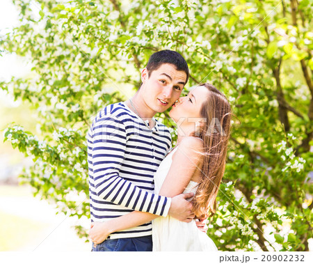 Loving couple under blossoming branches spring day 20902232