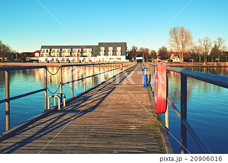 Wharf scaffold above  sea at harbor.House on coast 20906016
