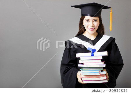 beautiful young  graduate holding diploma and book 20932335