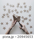 Woman's hands cut stars of craft paper 20945653