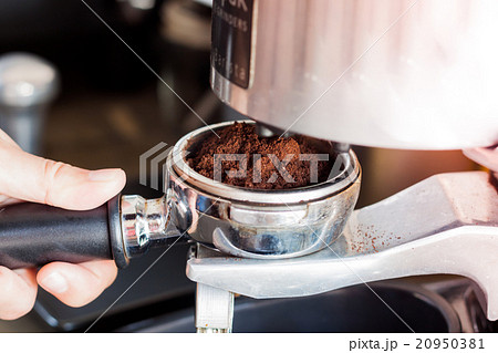 Woman's hand holding coffee grind in group  20950381