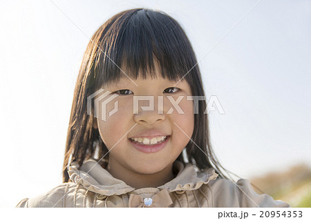人物 日本人 女の子 ポートレート 小学生 笑顔 カメラ目線の写真素材