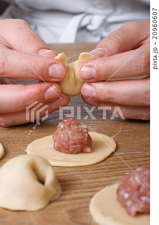 Hands cooks prepare dumplings close-up vertical Hands cooks prepare dumplings close-up vertical 20960607