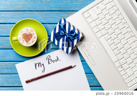 paper, gift, coffee and laptop lying on the table 20968016