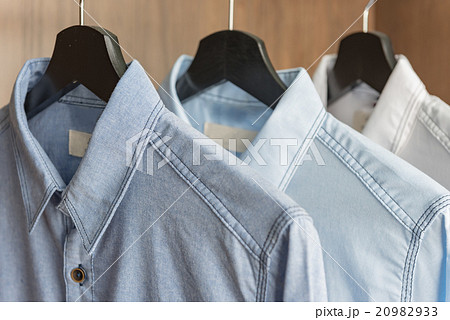 blue and white shirts hanging on rail blue and white shirts hanging on rail 20982933