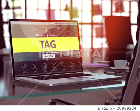 Tag on Laptop in Modern Workplace Background. 20989234