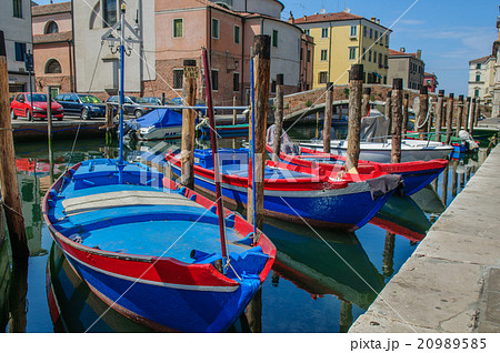 Fisherman boats moored along channel 20989585